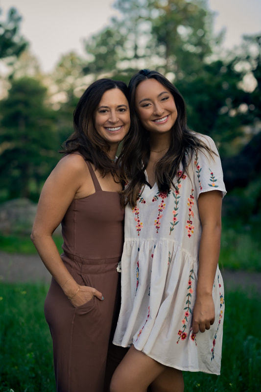 Girl in white dress with her mom standing next to her rocky mountains Morrison Colorado senior pictures 