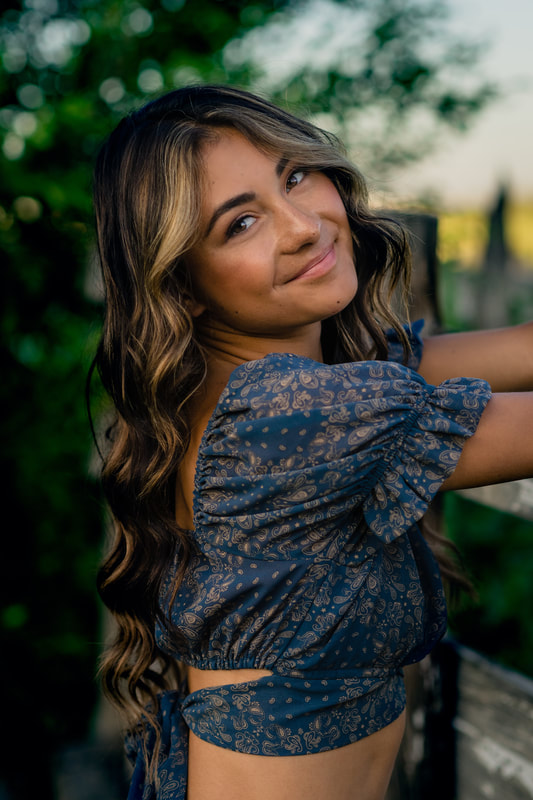 Girl in blue dress on a farm senior pictures golden hour broomfield colorado