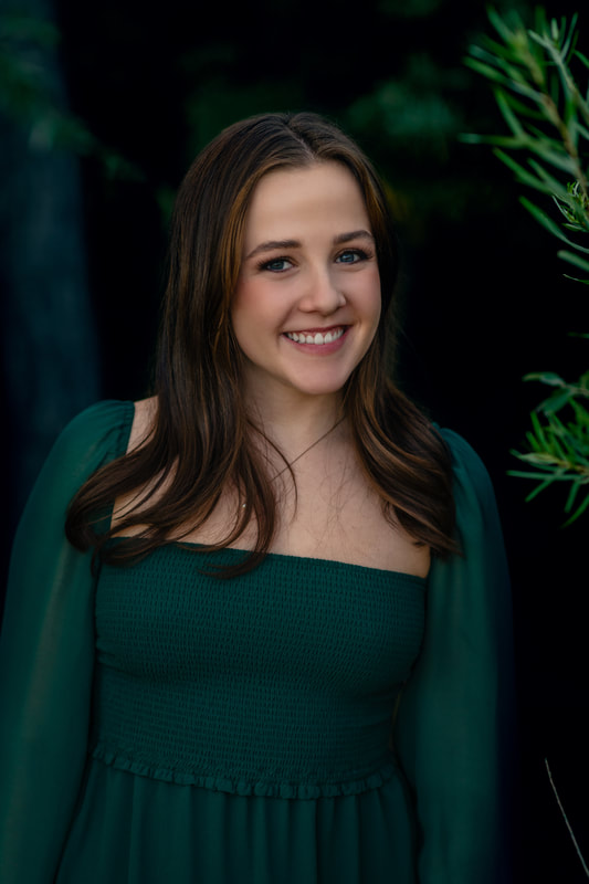 girl in green dress in forest senior pictures broomfield colorado