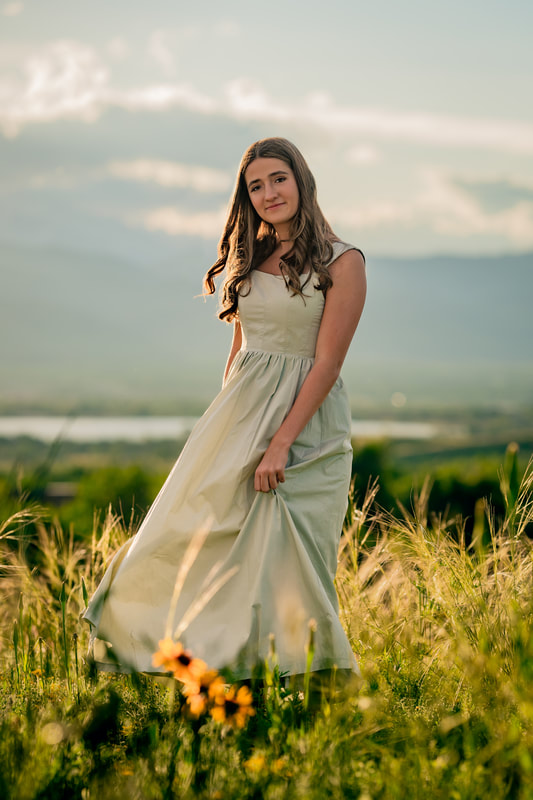 Girl in White dress flower filed rocky mountains parker colorado senior photoshoots