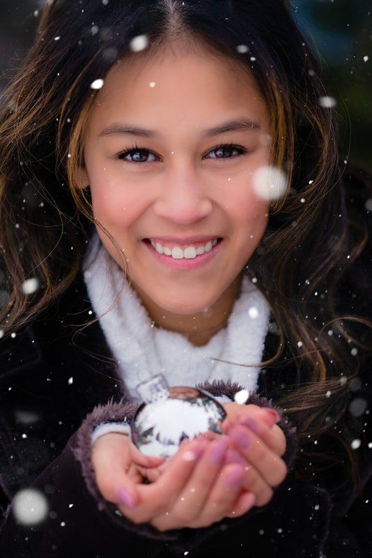 Senior picture ideas with snow and ornament for Christmas