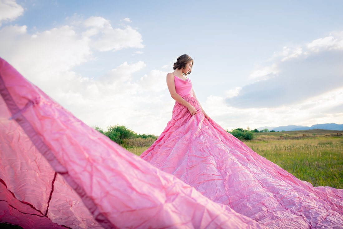 Brunette girl looking away for camera in pink dress for senior pictures